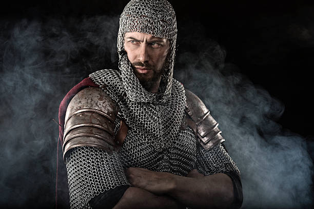 Medieval Warrior with chain mail armour Portrait of Medieval Dirty Face Warrior with chain mail armour. Smoke Cloud on Dark Background knights templar stock pictures, royalty-free photos & images