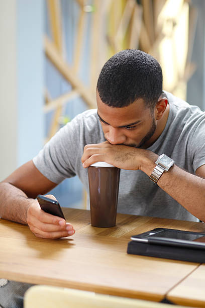 istock Man Using Mobile Phones In The Cafe 525042025