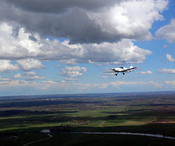 istock Small private civil sporting aircraft - cloud sky 525042038