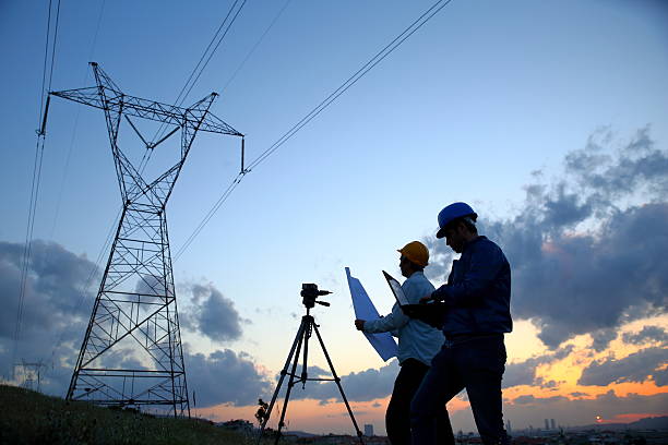 istock Silhouette of engineers workers at electricity station 525043224