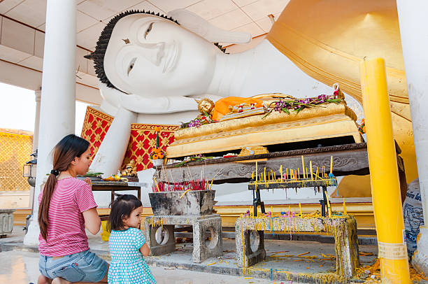 Nonthaburi, Thailand-February 19, 2016 : mother and daughter pay respect to sleeping buddha statue