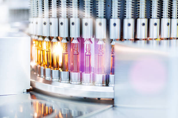 Vials medical Optical control quality of a vials, pharmaceutical factory.Lens flare pharmaceutical factory stock pictures, royalty-free photos & images