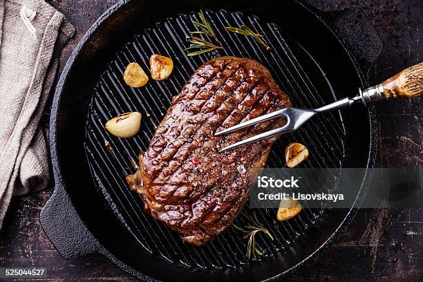 Ribeye Steak And Meat Fork On Grill Pan Stock Photo - Download Image Now - Beef, Black Color, Close-up