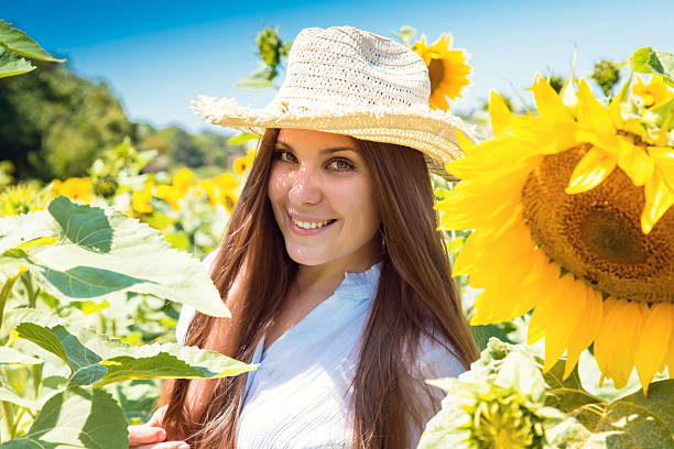 istock young beautiful woman between sunflowers 525056331