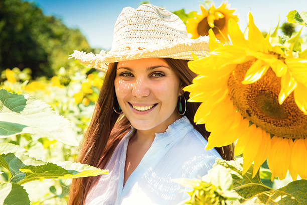 istock young beautiful woman between sunflowers 525056335