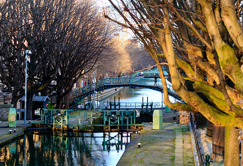 Canal Saint-Martin in Paris by winter time at sunset. It's an artificial 4.5km long waterway connecting the Canal de l'Ourcq to the river Seine.