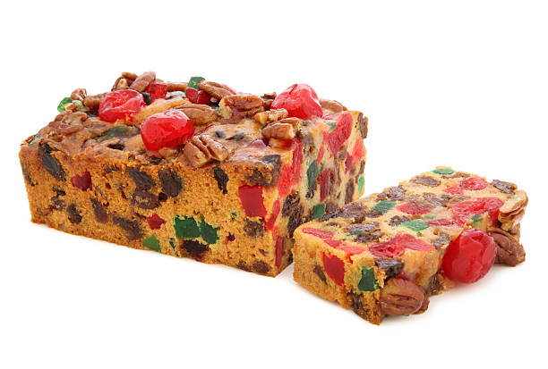 Holiday Fruit Cake Fruit Cake isolated on white fruitcake stock pictures, royalty-free photos & images