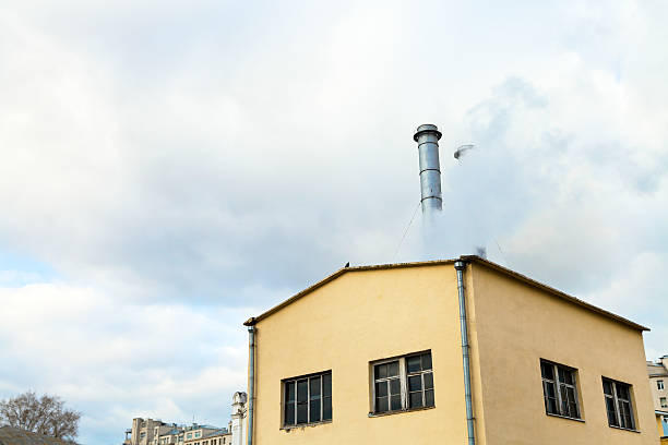 istock Central heating station and fume from chimney 525056991