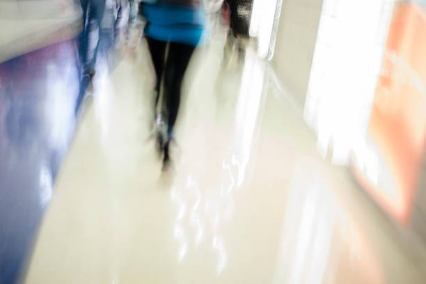 istock Blurred motion of people walking inside convention center hall. 525057487