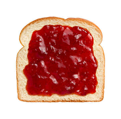 Aerial view of bright red strawberry preserves, spread over a slice of white bread. This can be eaten as shown or combined with another piece of bread and other ingredients to make a sandwich. The subject is isolated on a white background and was shot with a Canon EOS-1 Ds Mark II.
