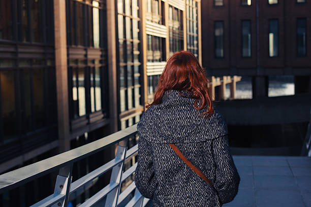istock Woman walking in street 525058307