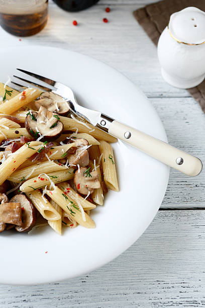 istock Pasta penne with pieces of mushrooms 525071297
