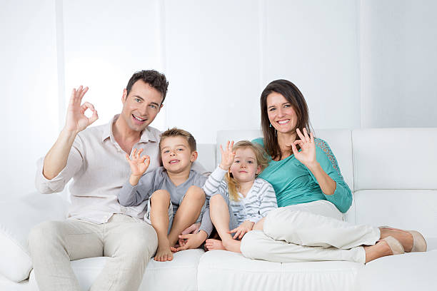 istock positive family sitting on sofa 525071423