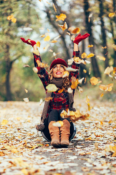 istock Beautiful blonde throwing leaves in the air 525072157