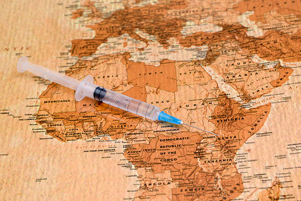 syringe on a map of africa Photo of syringe on a map of africa, antique style. May be used as illustration for medical theme. ebola stock pictures, royalty-free photos & images