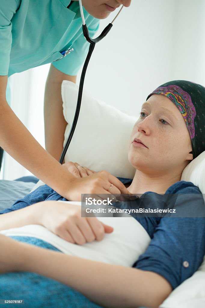 Teenage girl suffering from leukemia Teenage girl suffering from leukemia being examined Cancer - Illness Stock Photo
