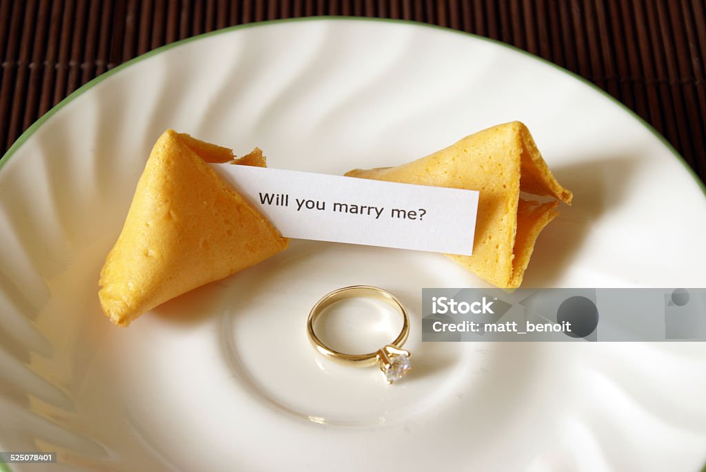 Fortune Cookie Proposal A marriage proposal using a fortune cookie and gold ring. Asking Stock Photo