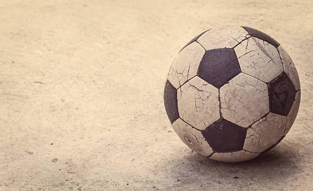 Old football on concrete background, Old football on concrete background, retro style old football stock pictures, royalty-free photos & images