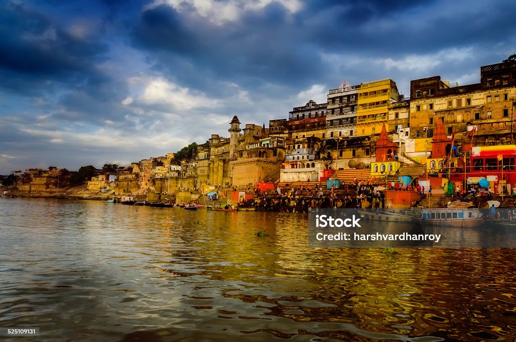 big wooden boats in water with cloudy sky and sunbeams big wooden boats in water with cloudy sky and sunbeams at allahabad indian asia Prayagraj Stock Photo