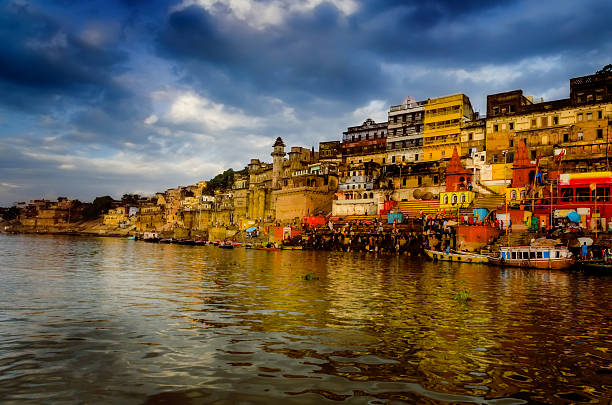 big wooden boats in water with cloudy sky and sunbeams big wooden boats in water with cloudy sky and sunbeams at allahabad indian asia prayagraj photos stock pictures, royalty-free photos & images
