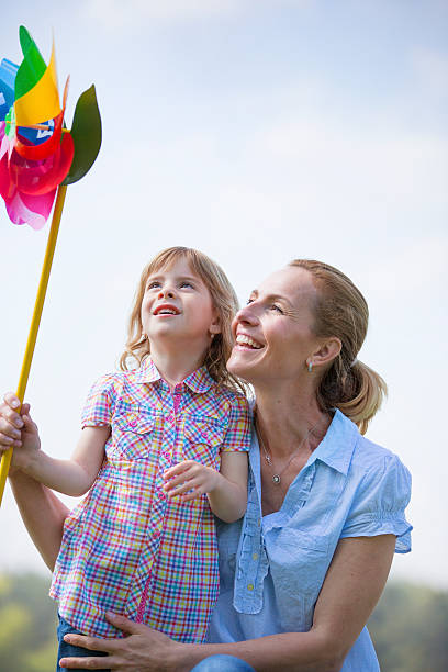 istock Mother and daughter with paper wind wheel 525111419