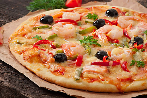 istock Pizza with shrimp, salmon and olives 525120441