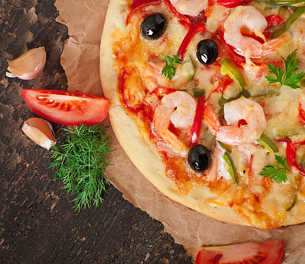 istock Pizza with shrimp, salmon and olives 525120457