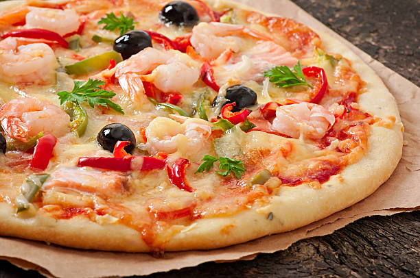 istock Pizza with shrimp, salmon and olives 525120459