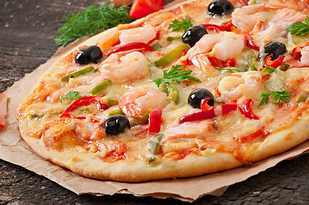 istock Pizza with shrimp, salmon and olives 525120461