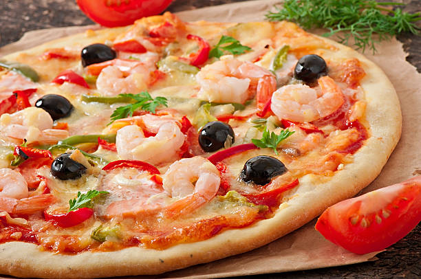 istock Pizza with shrimp, salmon and olives 525120463