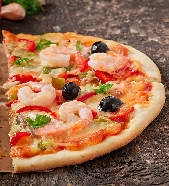 istock Pizza with shrimp, salmon and olives 525120467