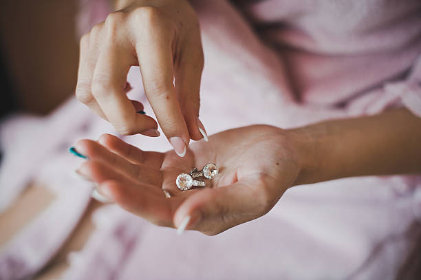 istock Earrings from pearls in hands 1278. 525121927