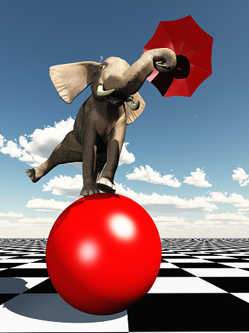 Rendered elephant using umbrella to balance on red ball. The key concept here is balance whether in terms of a judgement call or simply balancing the books.