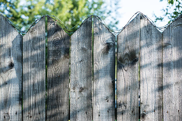 istock old wooden fence with barbed wire on top 525124541