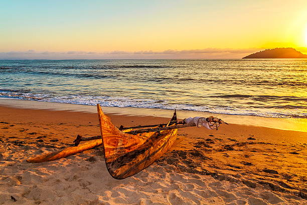 Old Catamaran on the Beach at Nosy Be Island Old Catamaran on the Beach at Nosy Be Island at Sunset,Madagascar. madagascar beach photos stock pictures, royalty-free photos & images