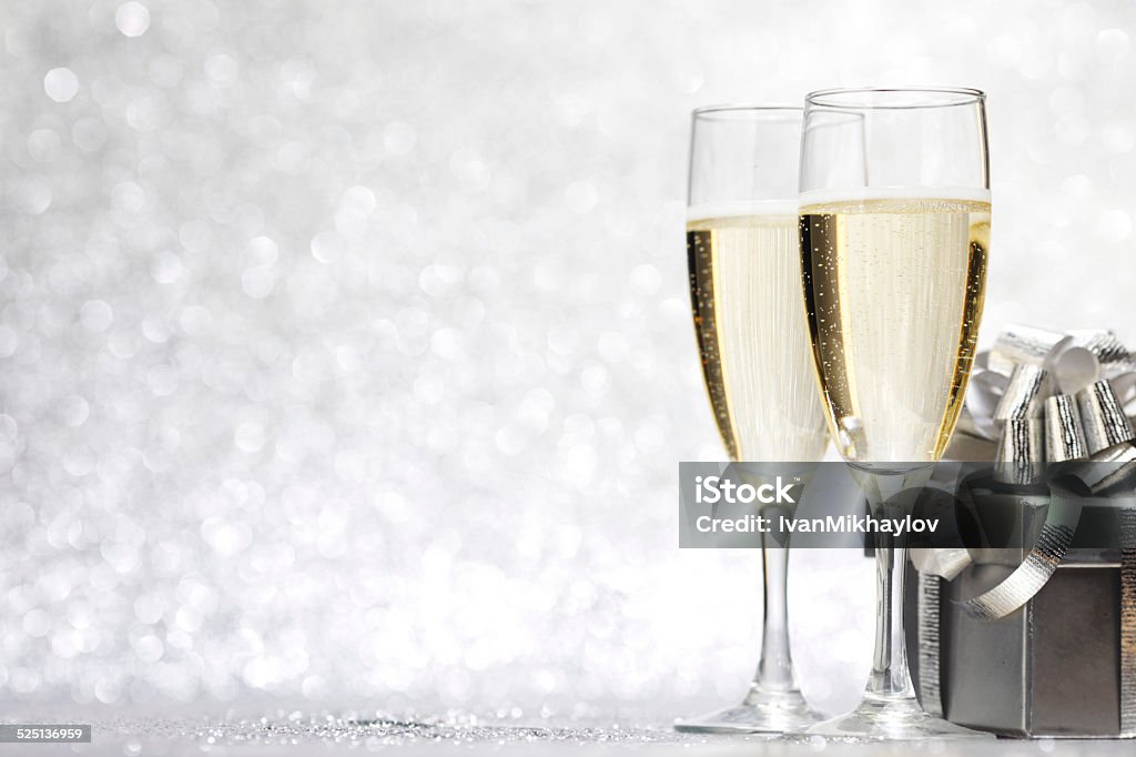 Champagne and present Champagne and present on silver bokeh background Champagne Stock Photo