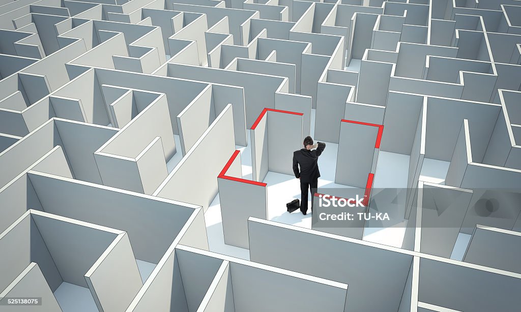 Businessman standing in center of the maze. Make a difficult decision. Achieving the goal. Wide angle. Encounter difficulties. with a stroke. Abstract Stock Photo