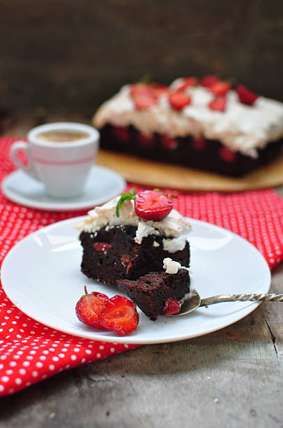istock Chocolate brownies with strawberry and meringue, selective focus 525138095
