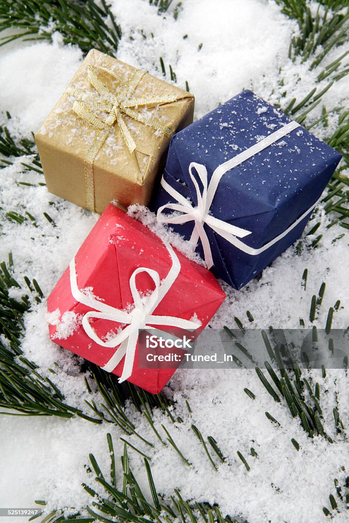 Christmas parcels on snow-covered fir branch, close up Christmas parcels on snow-covered fir branch, close up. Blue Stock Photo