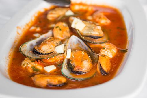 Mussels in shell in tomato sauce - traditional greek mussels saganaki