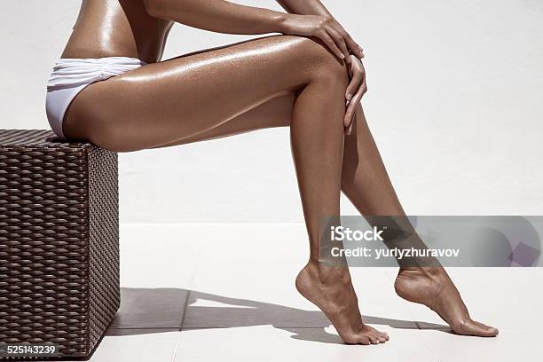 Beautiful Woman Tan Legs Against White Wall Stock Photo - Download Image Now - Sun Tan, Women, The Human Body