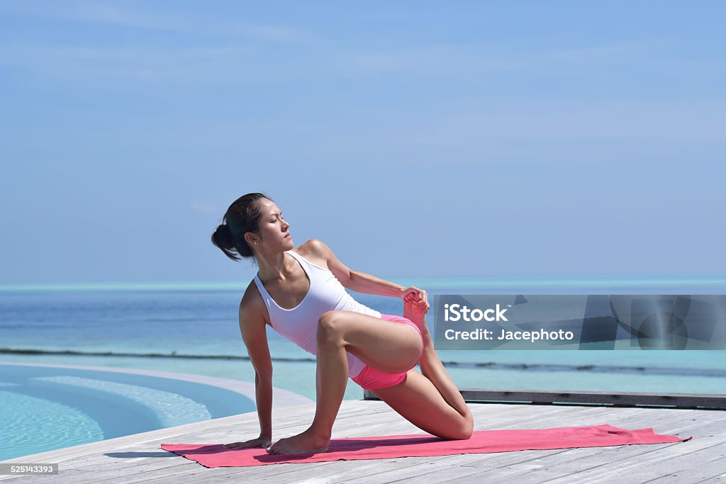 Asian Chinese Woman in Various Yoga Poses at the Beach Stock Photo
