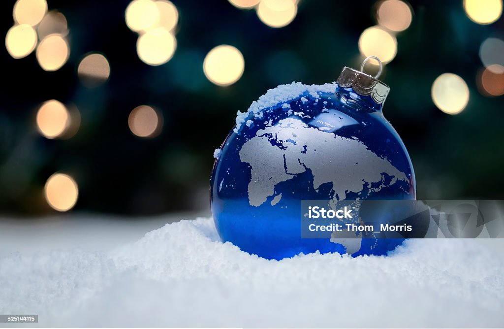 Christmas Ornament A Christmas ornament in the snow depicting the Eastern Hemisphere Globe - Navigational Equipment Stock Photo