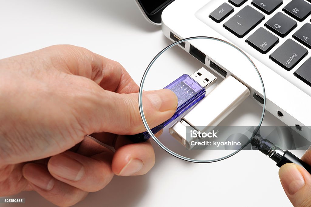 Looking for privacy with holding a magnifying glass Holding a magnifying glass and USB Flash Drive, looking for privacy isolated on white background. Analyzing Stock Photo