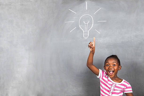 Little girl with a bright idea stock photo