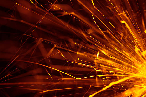 The glitter of sparkler flare A sparkler is a type of hand-held firework that burns slowly while emitting yellow flames and sparks. welding photos stock pictures, royalty-free photos & images