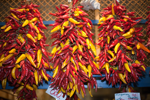Red and yellow peppers on market