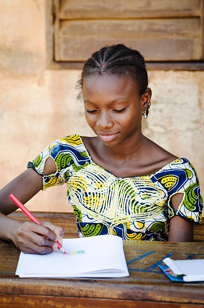 istock Writing Symbol - African School Girl Smiling - Education 525175833