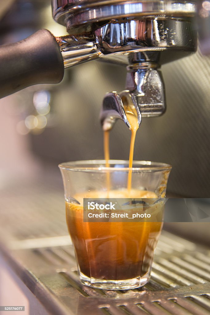 Espresso brewing Espresso in glass Barista Stock Photo