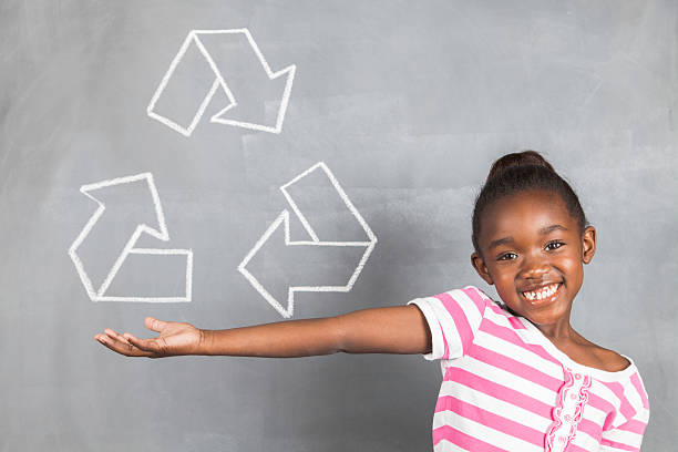 Beautiful african girl presenting the recycle symbol stock photo